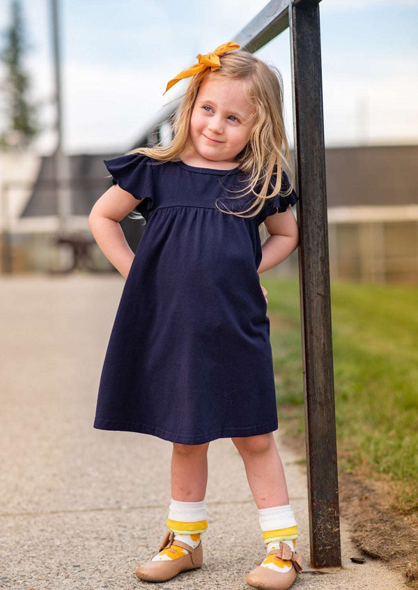 girl in blue dress at school